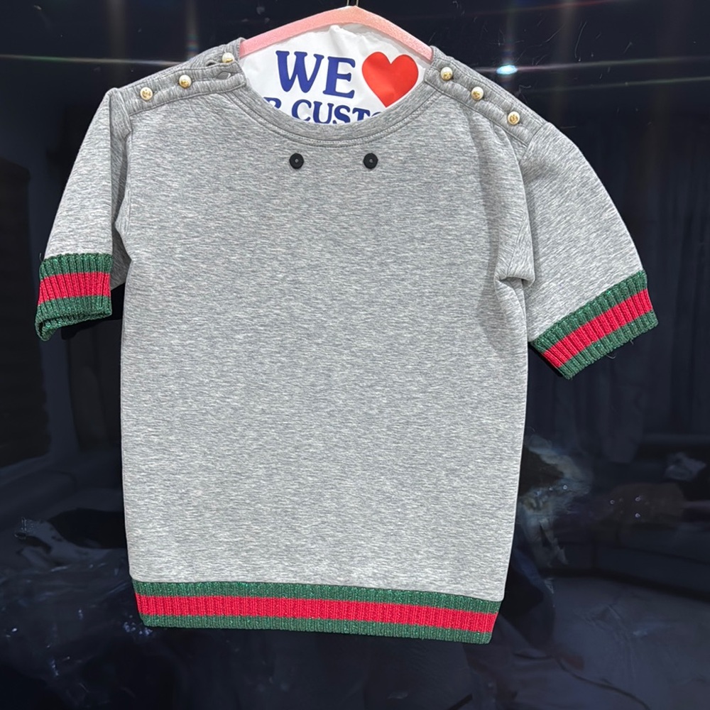 Gucci Gray and Green Short Sleeve Tee
Detaches signature Gucci brooch
